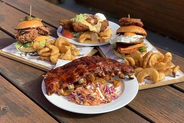 Various pub dishes on wooden table 